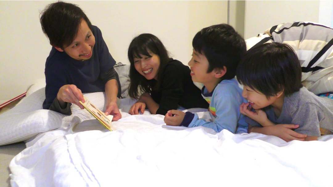 寝室で４人並んで絵本を読む.jpg